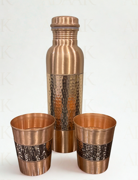 Set of two copper cups and a copper bottle with hammered design on a white background