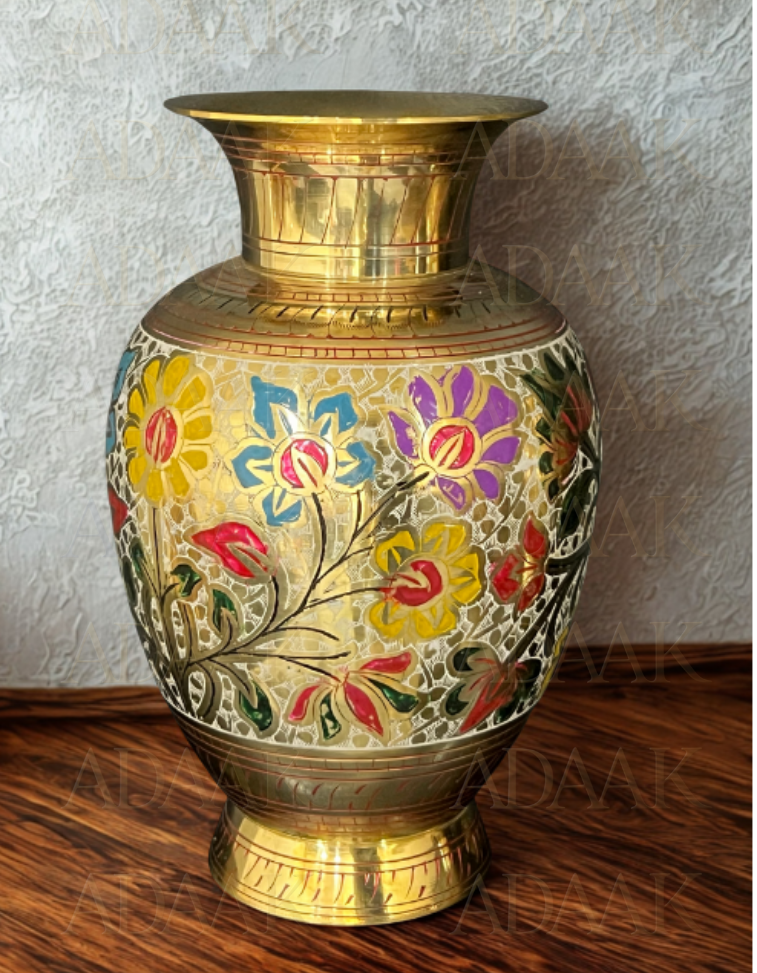 Decorative brass vase with floral patterns on a wooden surface