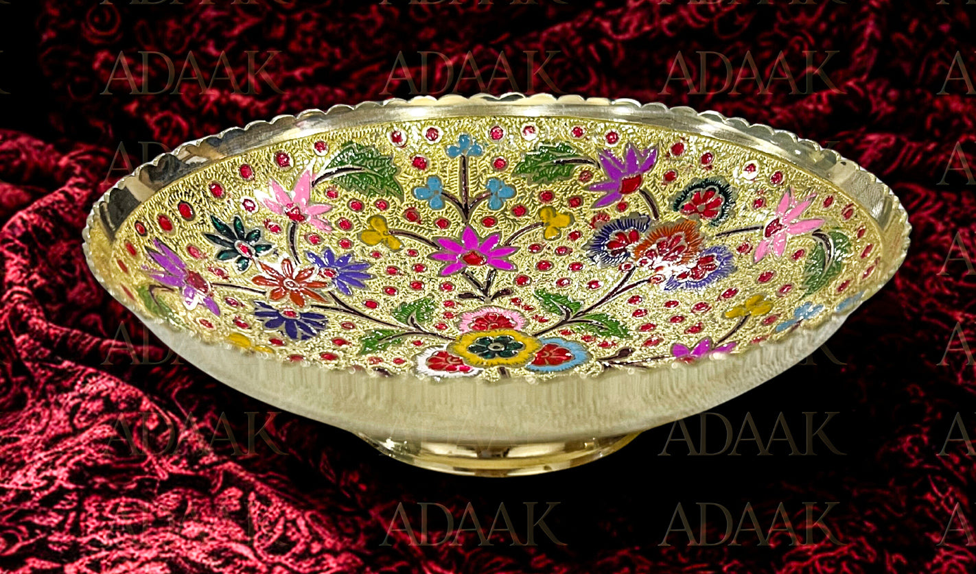 Decorative bowl with floral patterns on a red fabric background