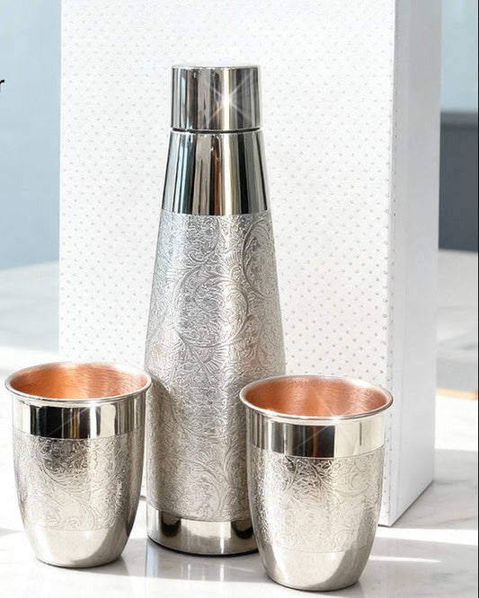 Nickle finish copper water bottle and cups with packaging on a light background, featuring Adaak brand.