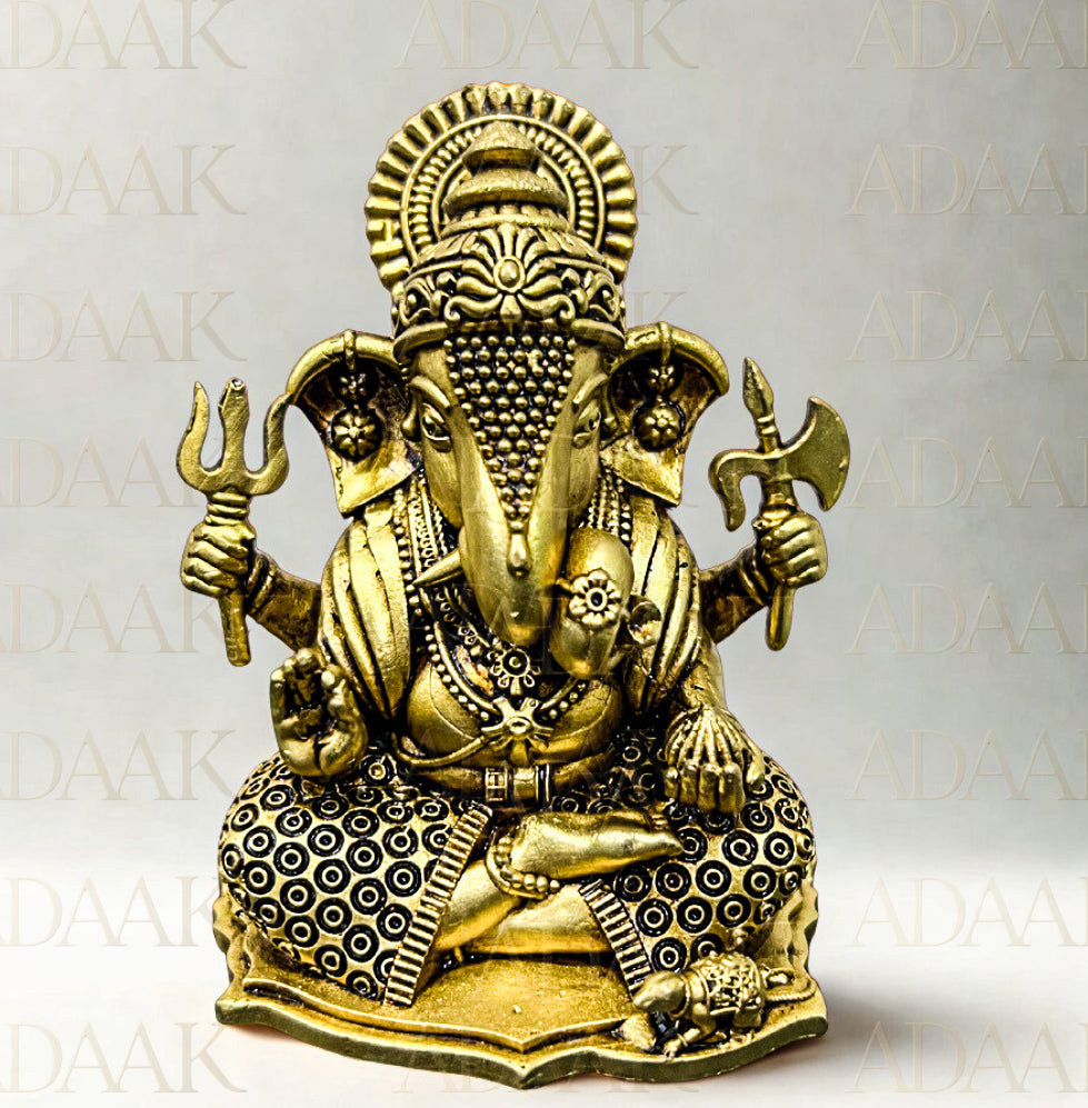 Brass statue of Ganesha on a white background