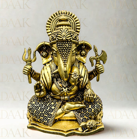 Brass statue of Ganesha on a white background