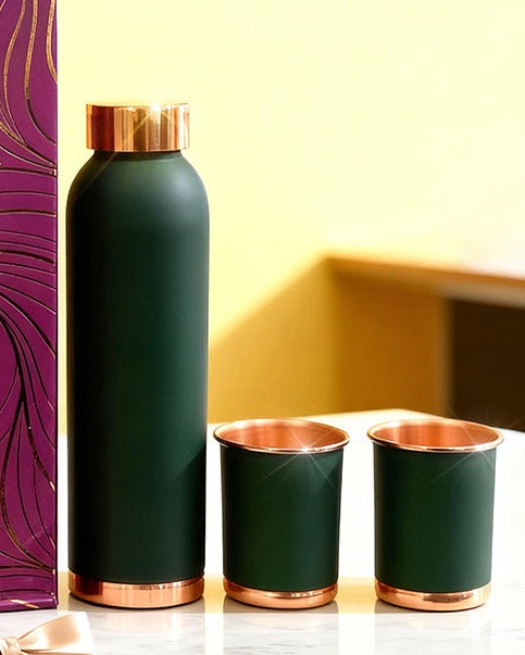 Luxury gift set with a purple box, green water bottle, and copper cups on a yellow background.