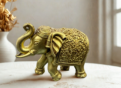 Decorative Brass elephant figurine on a marble surface with a blurred background