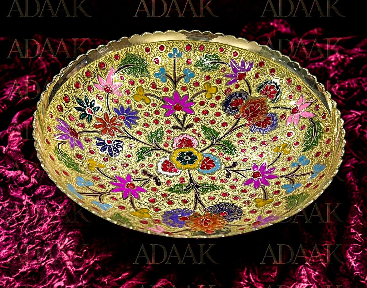 Decorative bowl with floral patterns on a pink textured background