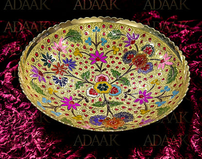 Decorative bowl with floral patterns on a pink textured background