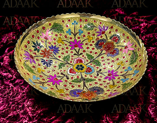 Decorative bowl with floral patterns on a pink textured background