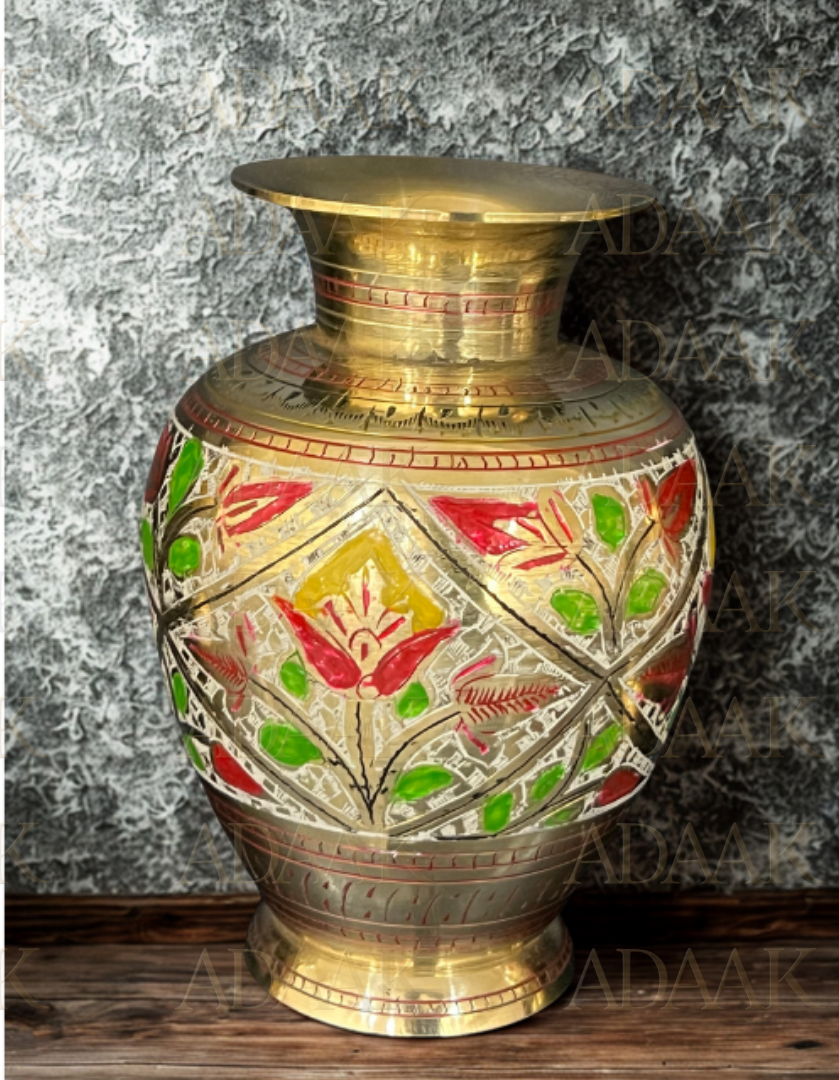 Decorative brass vase with floral patterns on a textured surface