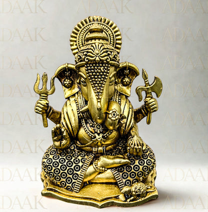 Brass statue of Ganesha on a white background